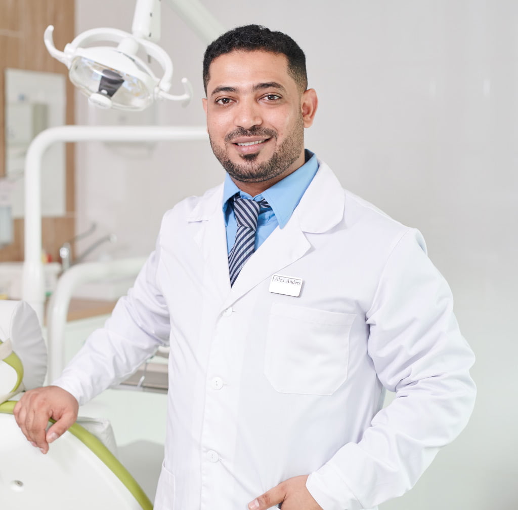 Tooth Filling 7 middle eastern dentist posing by chair 3WJ4MEV