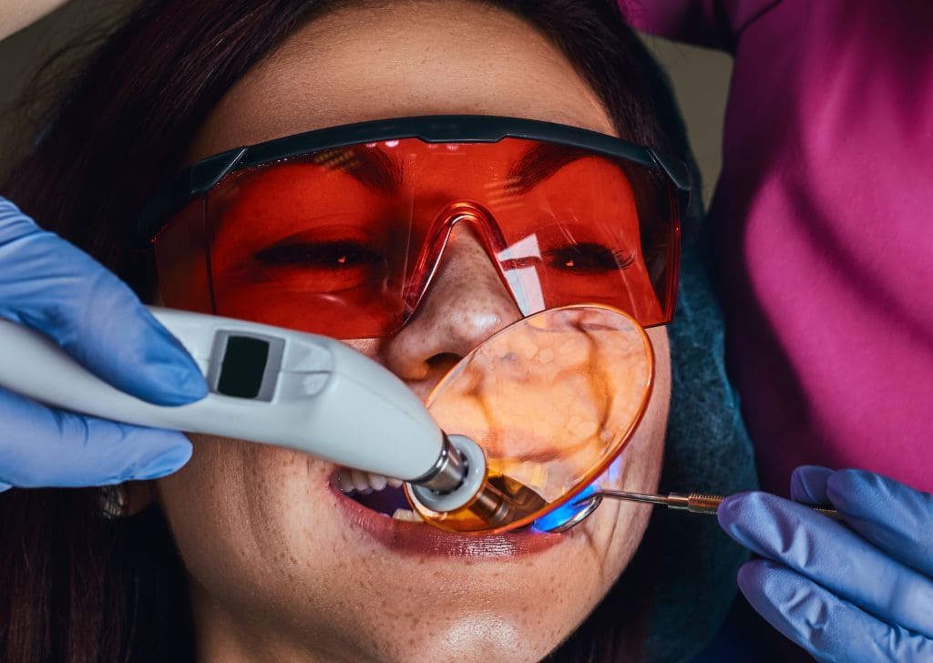 A patient getting laser dentistry for teeth whitening. 