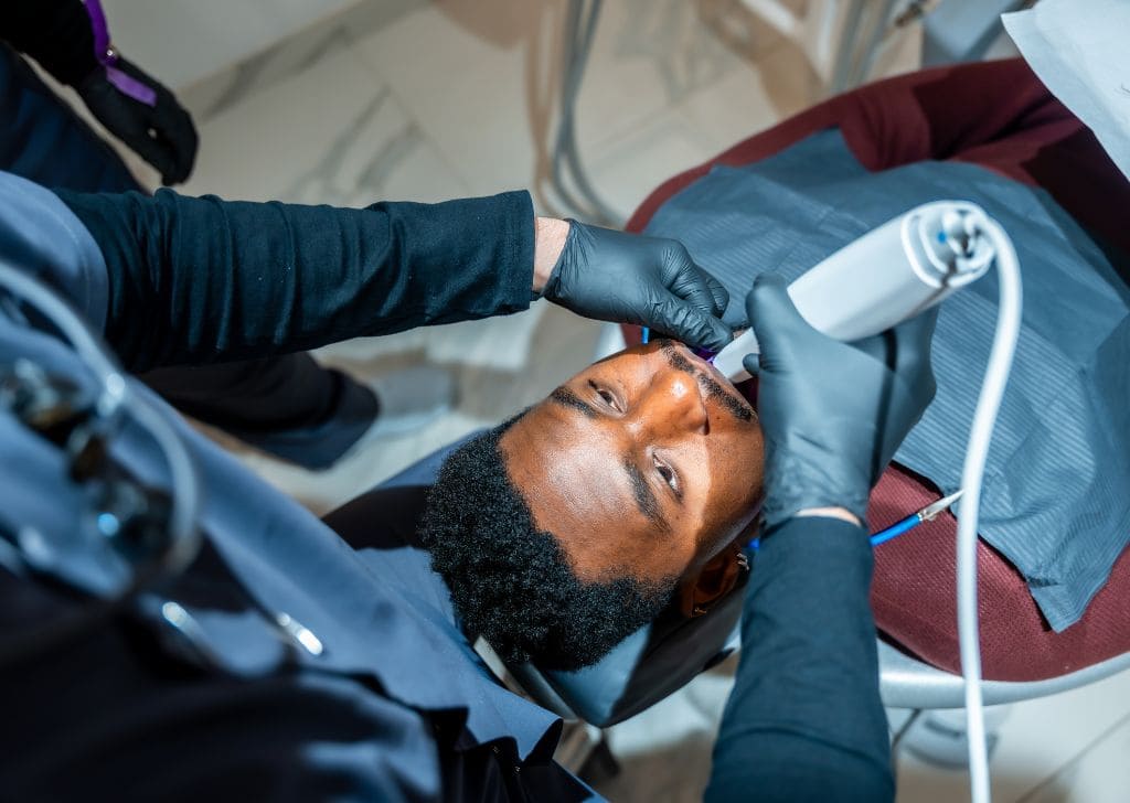 A patient getting his teeth whitening with laser dentistry in Kepong. 